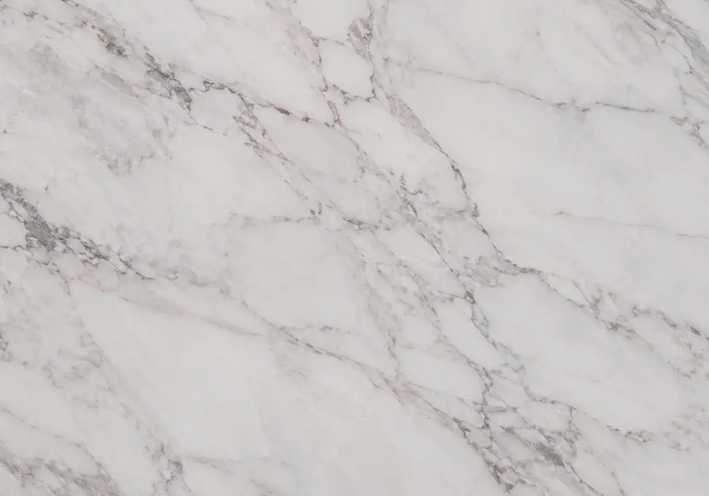 pink-red marble in a hotel lounge fireplace, showing natural slab variation, polished stone depth and architectural detail.