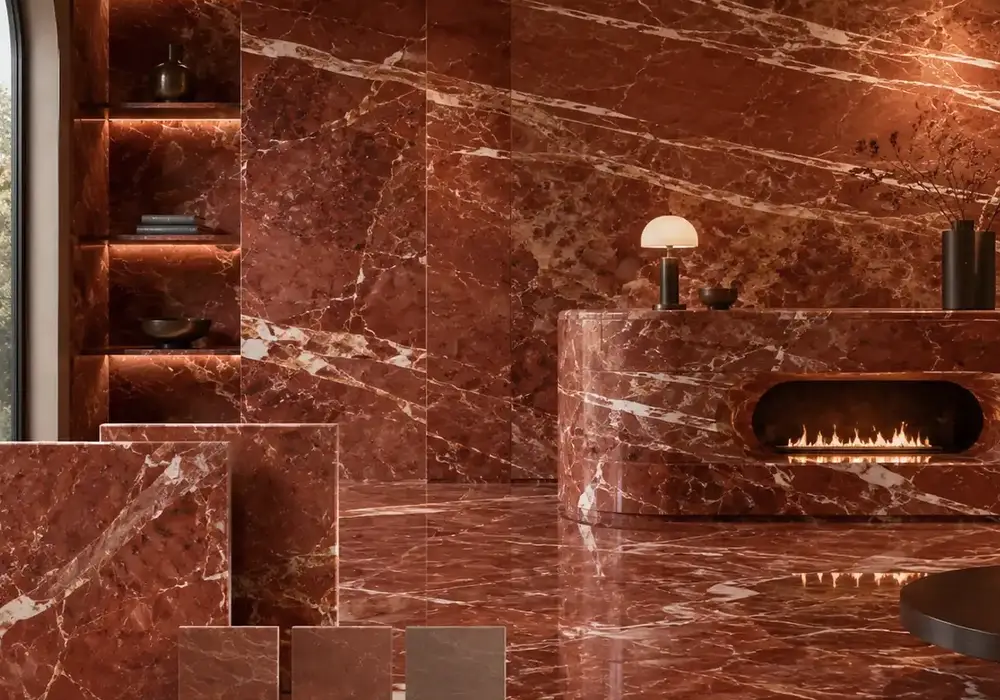 sophisticated red feature stone across wall cladding, large-format flooring and a countertop, with authentic slab variation.