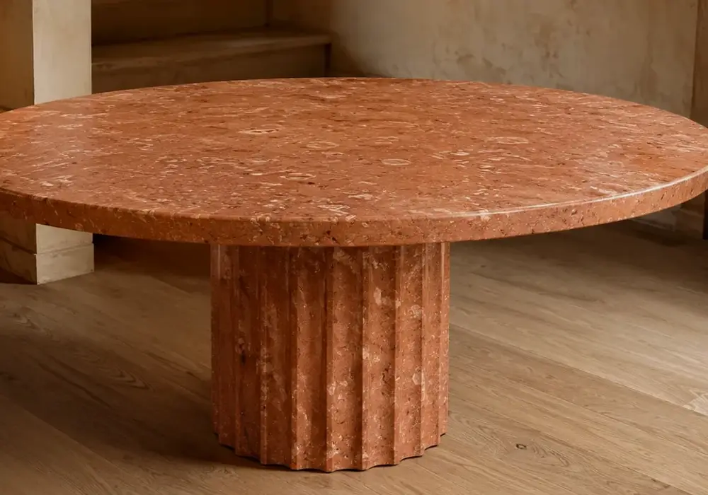 Rosso Verona marble console table with earthy red, terracotta and reddish-brown stone in a luxury gallery.