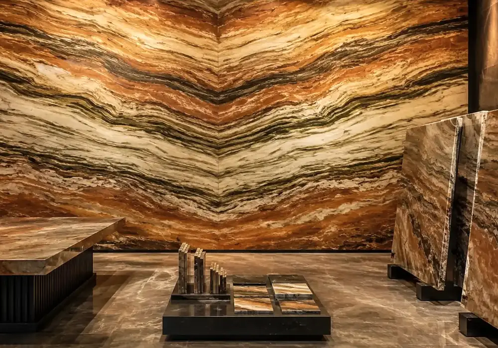 sophisticated statement stone across a feature wall, flooring and a sculptural countertop, with authentic slab variation.