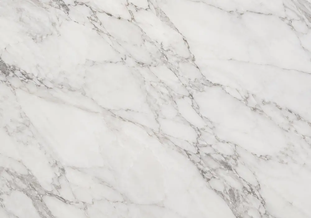 Snow White vs Makrana on island and shower wall, comparing crystalline white slabs with subtle grey-veined Indian stone.
