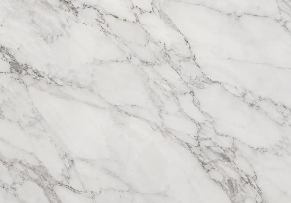 Sunny White Marble fireplace surround displayed in a premium gallery with full slabs and elegant architectural details