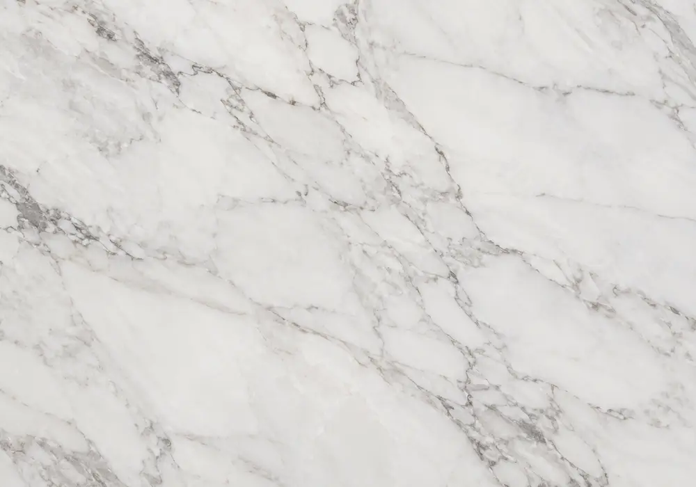 Tavera Marble console tabletop in a refined stone showroom with natural slab displays and polished surfaces