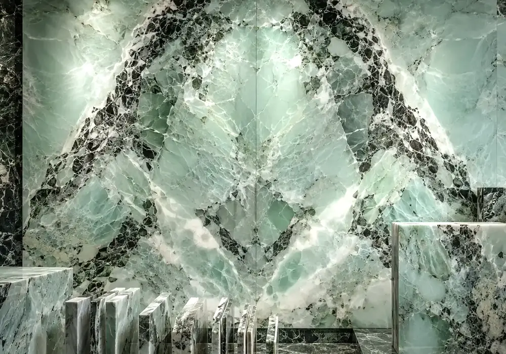 Deep forest-green Verde Alpi Marble carries luminous white fractures, showcasing dramatic Italian Alpine green marble beauty.