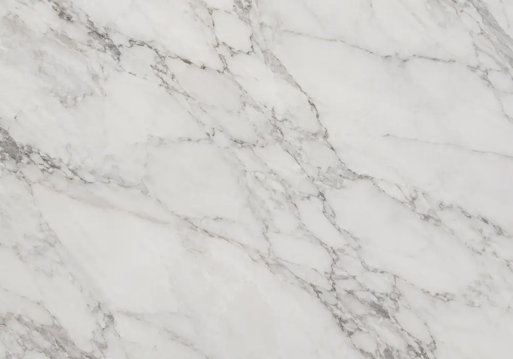 black-green marble slabs shown beside polished interior stone and honed exterior panels under varied strong UAE daylight.