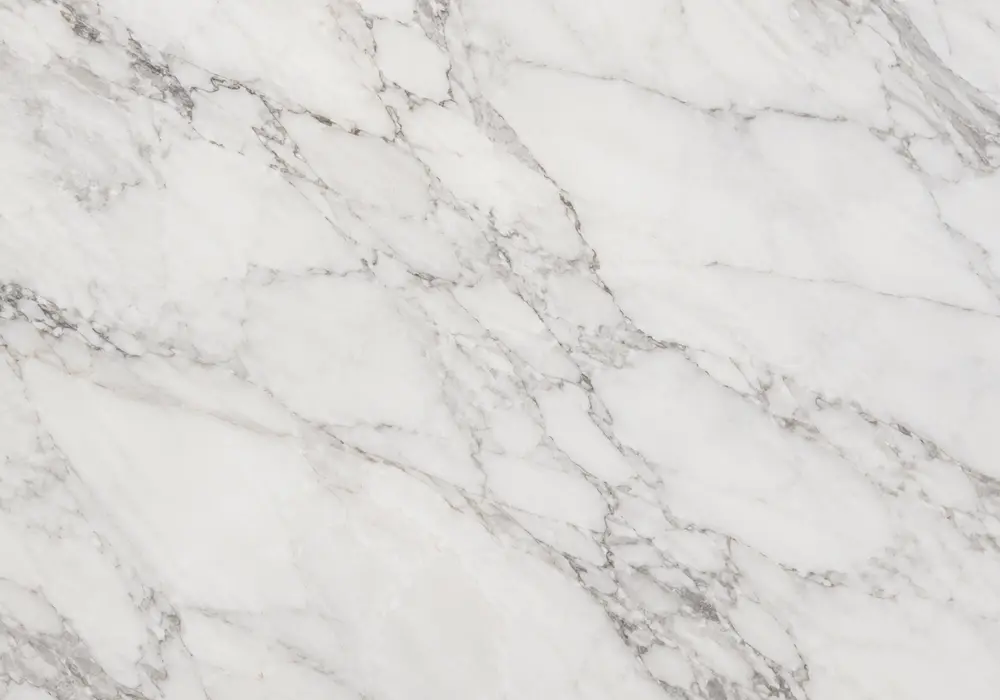 Verde Levanto marble shown as polished indoor slabs and honed, leathered exterior test panels under bright UAE sunlight.