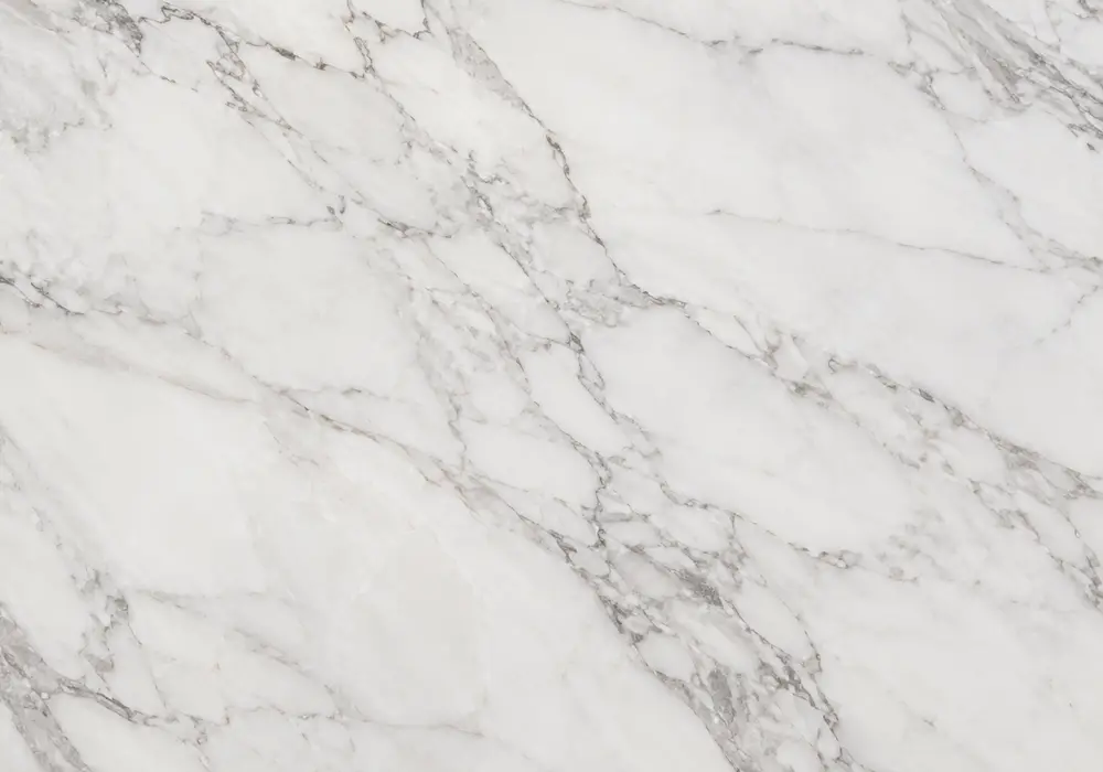 Volakas look tile on polished counter, vanity and feature wall, showing blue-grey stone with broad white cloudy movement.
