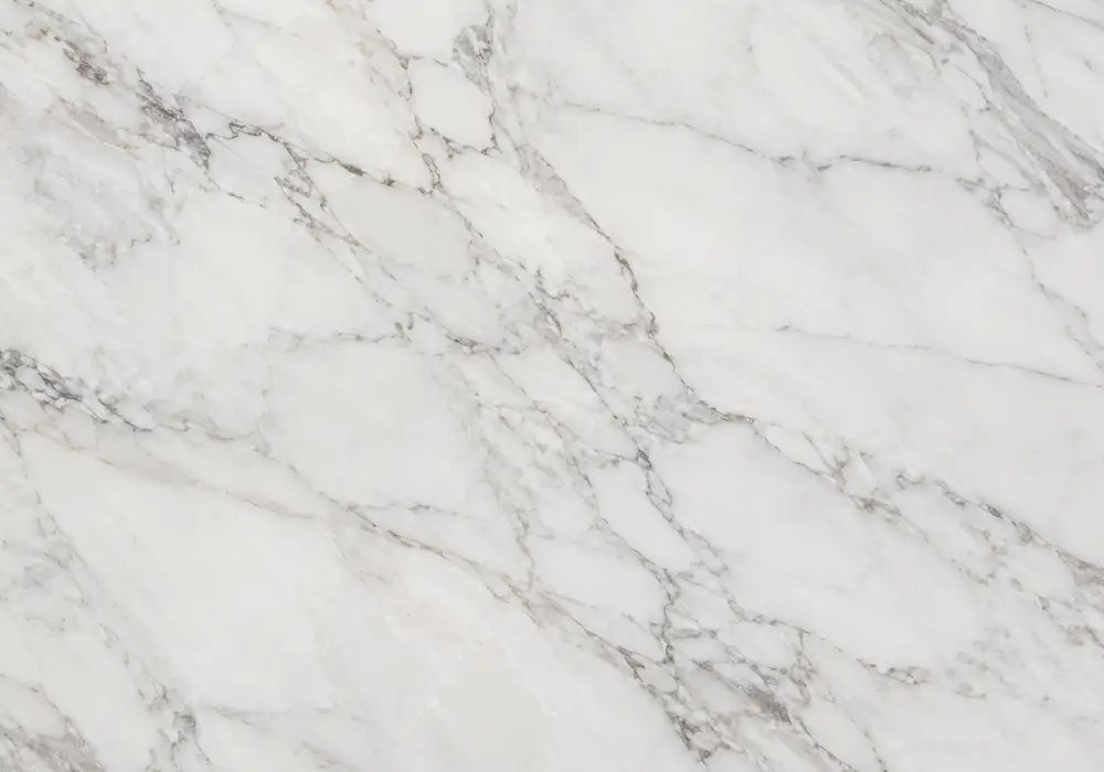 burgundy vein marble slabs displayed in a luxury showroom with polished sample pieces, bespoke edges and UAE-ready stock.