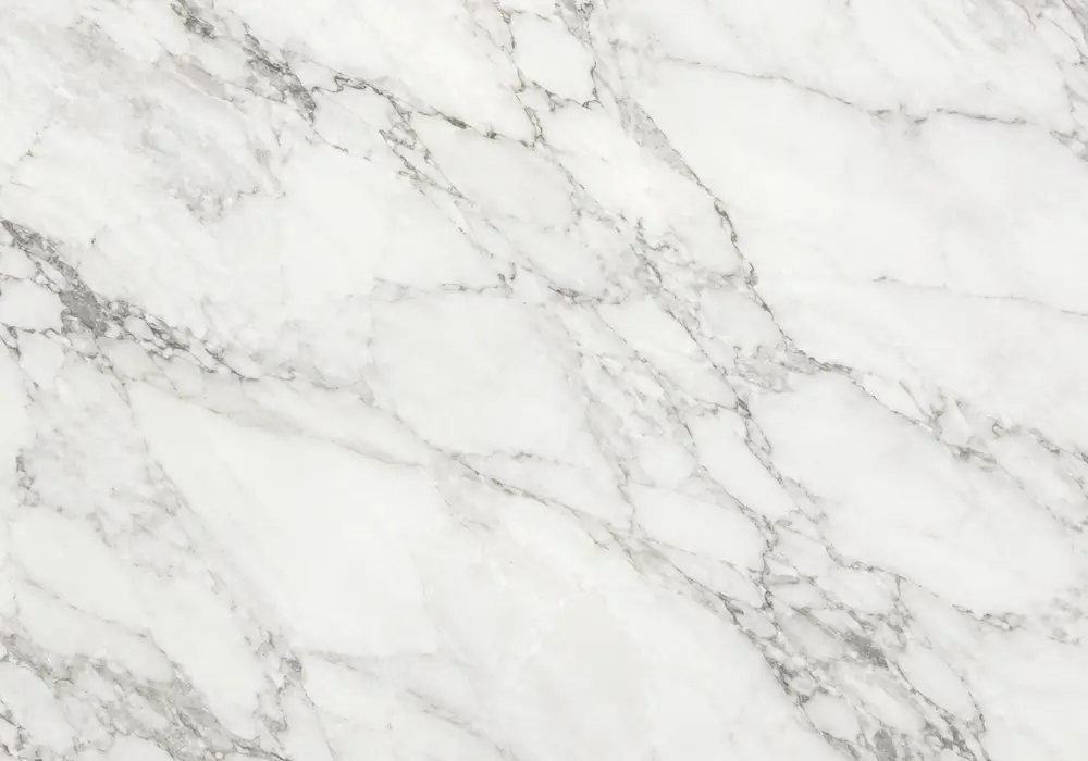 Volakas Gold Marble bookmatched fireplace wall with creamy white stone and flowing warm-gold veins.
