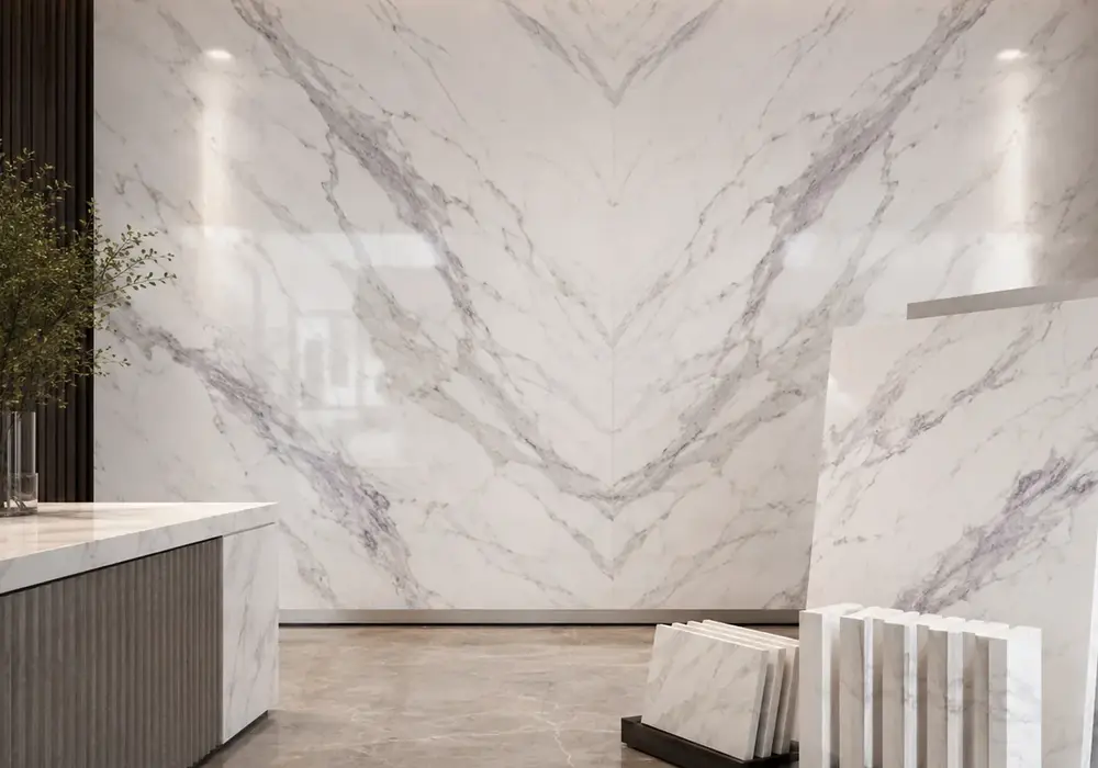 Volakas Marble foyer reception wall displayed with full stone slabs in a contemporary luxury showroom