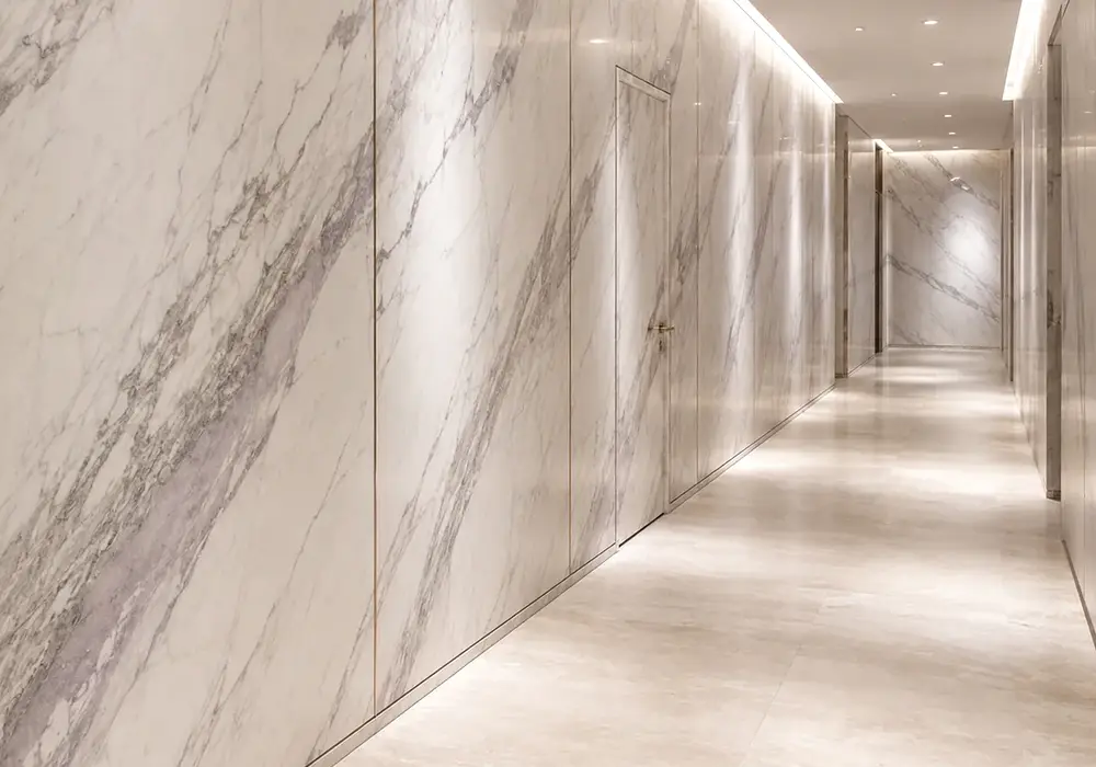 Volakas Classic in a residential foyer and staircase, with natural veining, refined stone texture and architectural detail.