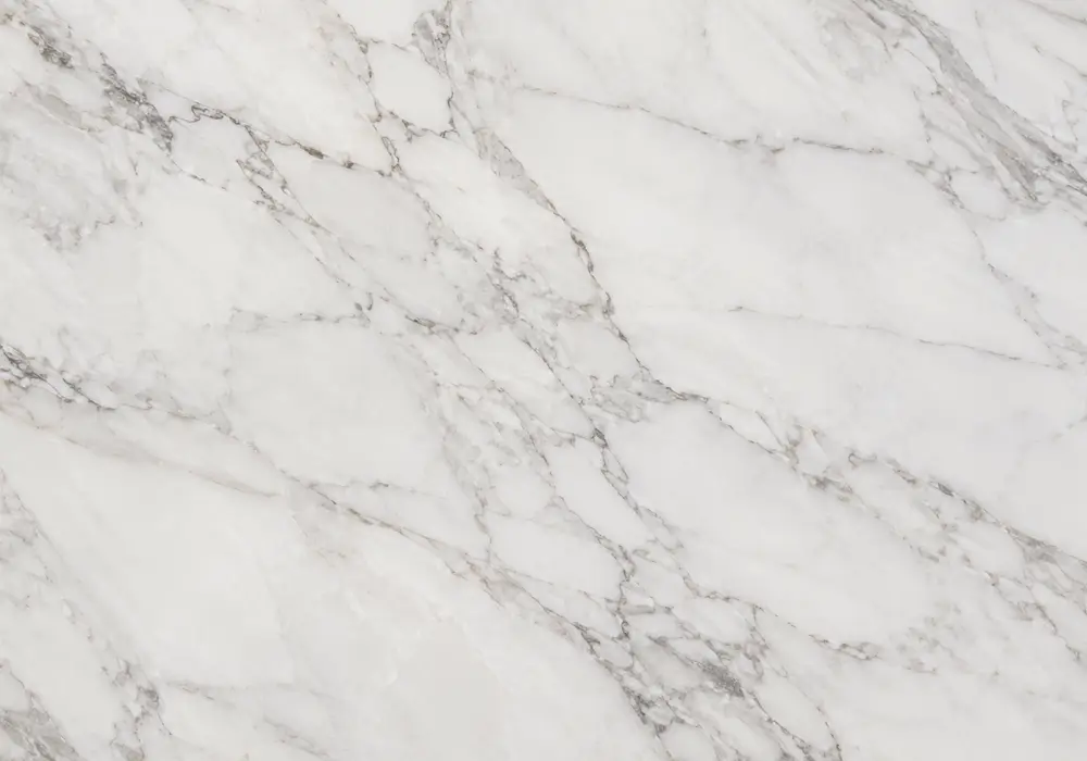 Volakas White Marble dining tabletop in a refined material gallery with natural slabs and coordinated wall finishes