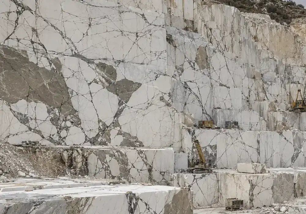 white grey marble slabs on polished kitchen and vanity surfaces with honed floors, stairs and fine-to-flowing grey veins.