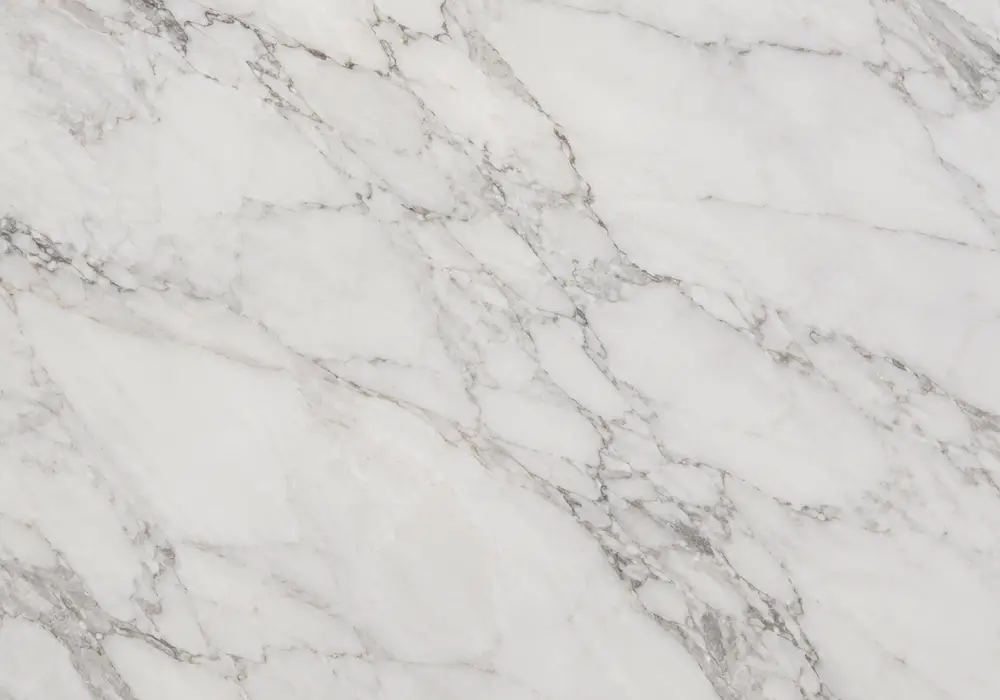 White Marble fireplace surround in a luxury stone showroom with upright slabs and refined wall finishes