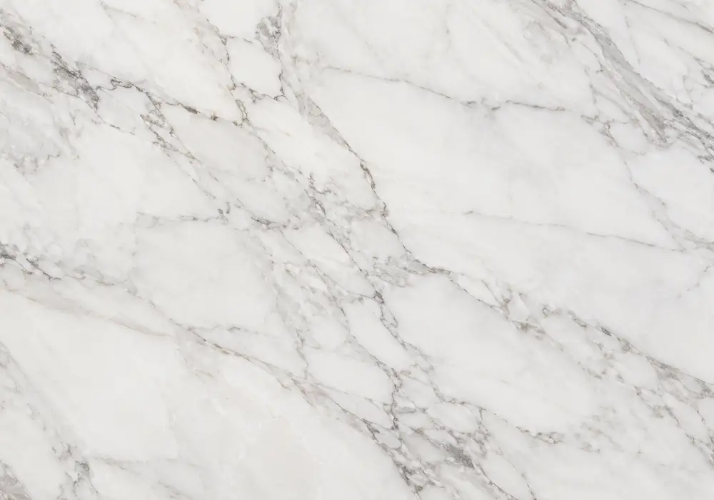 White Statuario marble bookmatched reception wall with crisp white stone and controlled grey, silver and charcoal veins.