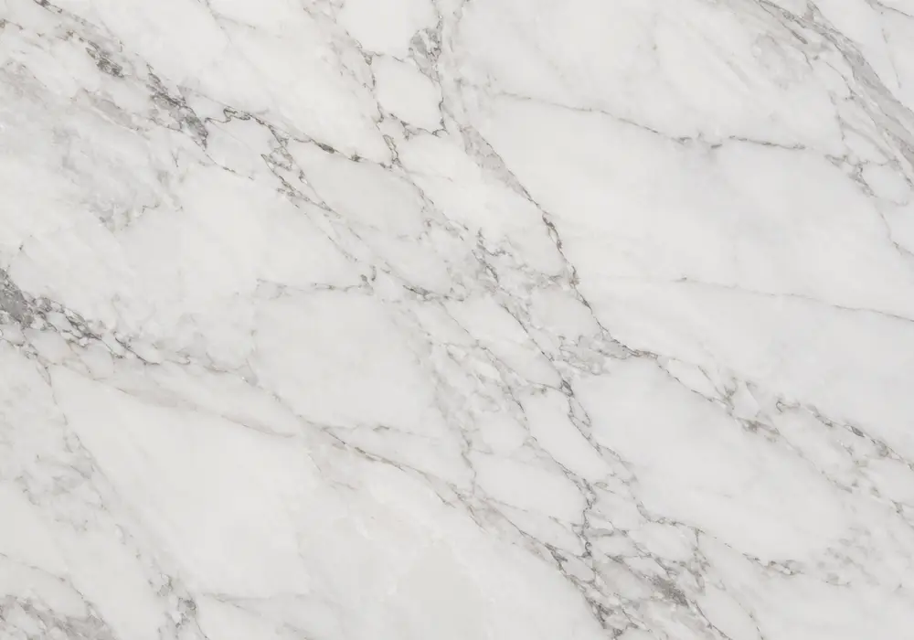 White Statuario slabs in Venato and Extra-style grades shown polished and honed with open white areas and UAE project samples