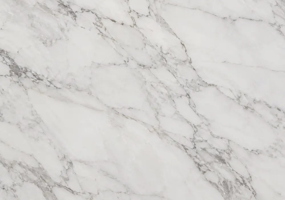 Premium Statuario White marble slab with crisp white space, bold cool-grey ribbons and controlled architectural veining.