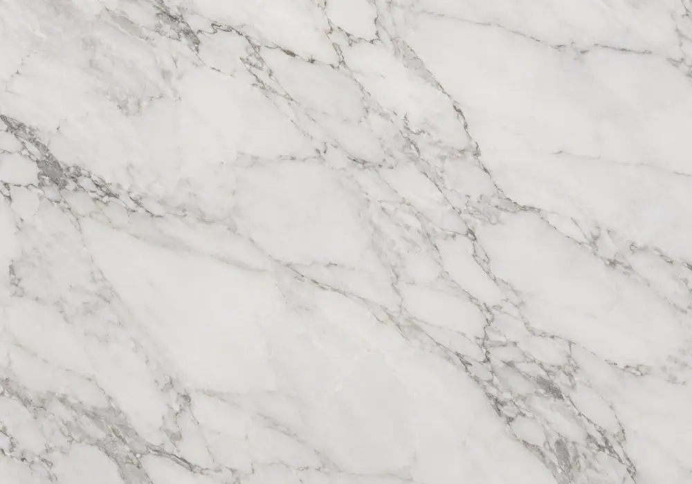 Elegant Volakas White marble slab with milky tones, diagonal silver-grey bands, warm hazelnut veins and crystalline depth.