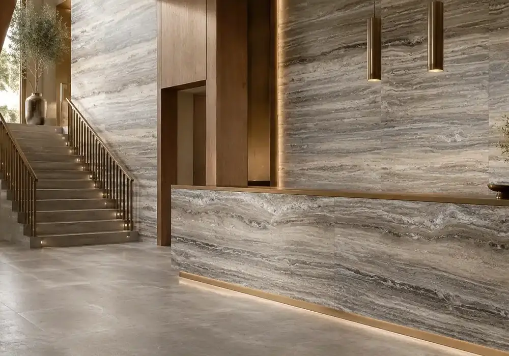 sophisticated grey feature stone across wall cladding, large-format flooring and a countertop, with authentic slab variation.